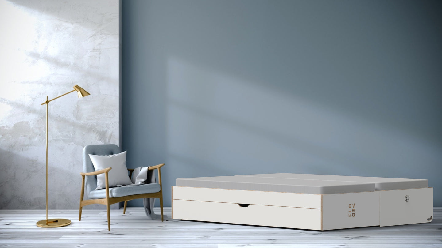 The FLOVED sofa bed stands unfolded in a room